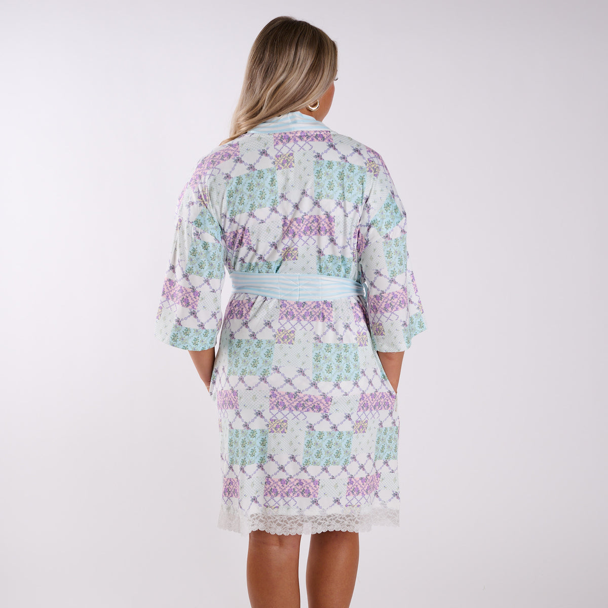 Patchwork floral robe back view with relaxed fit, mid-length silhouette, and striped belt.