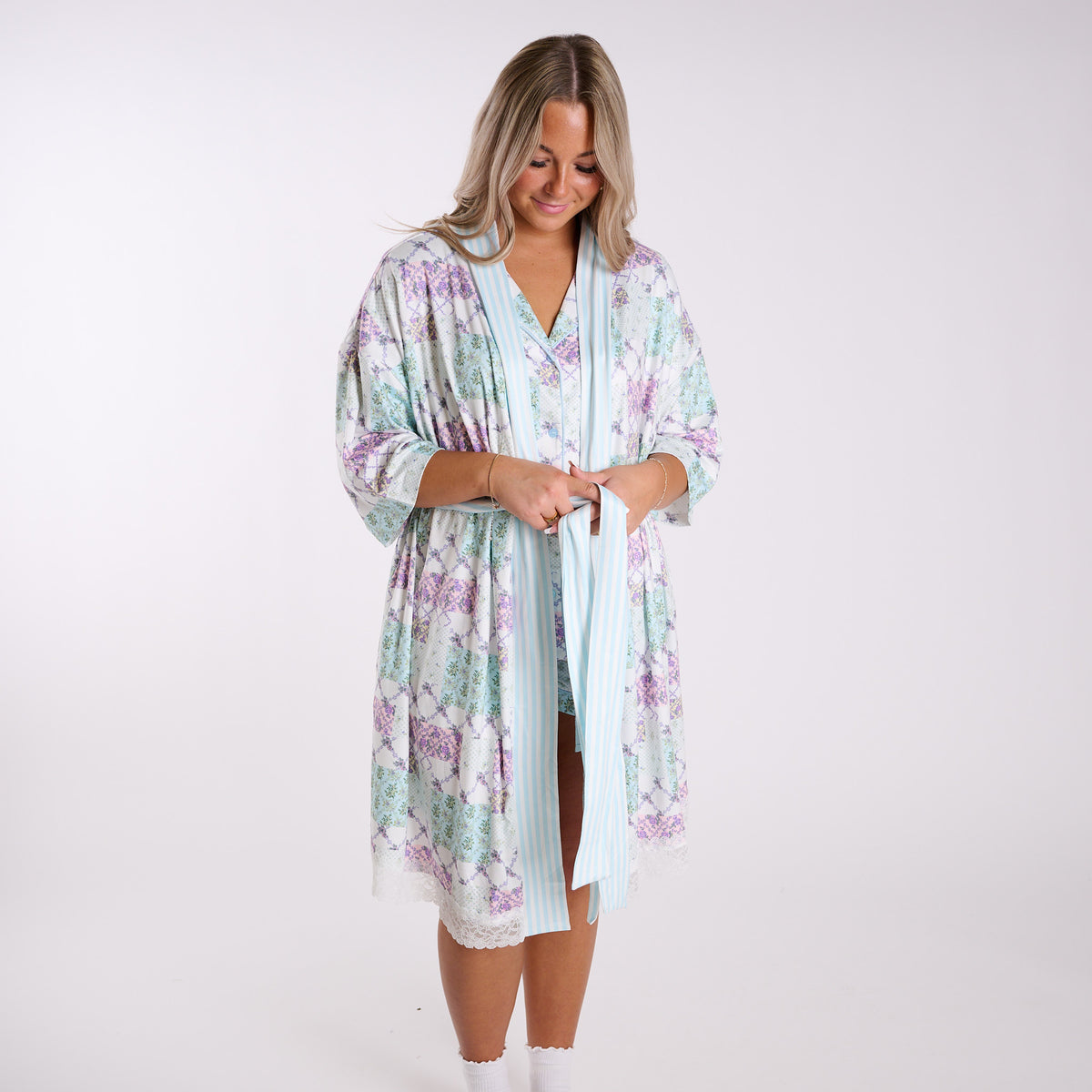 Patchwork floral robe front view with tie waist, side pockets, and lace trim hem.