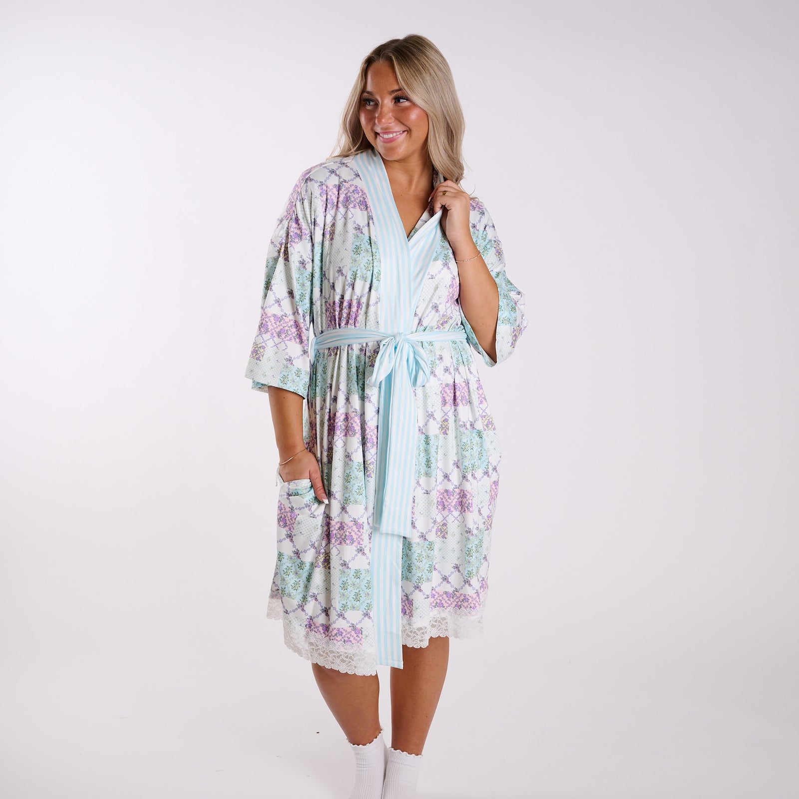 Floral patchwork robe full body view showing relaxed fit, striped trim, and soft fabric.