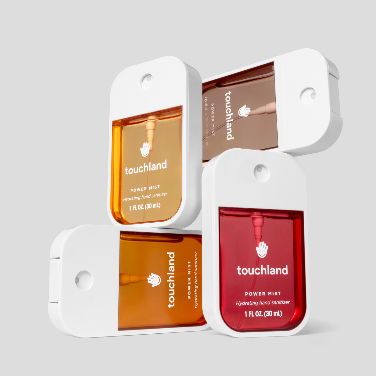 Three bottles of Touchland hand sanitizers in different colors on a light gray background