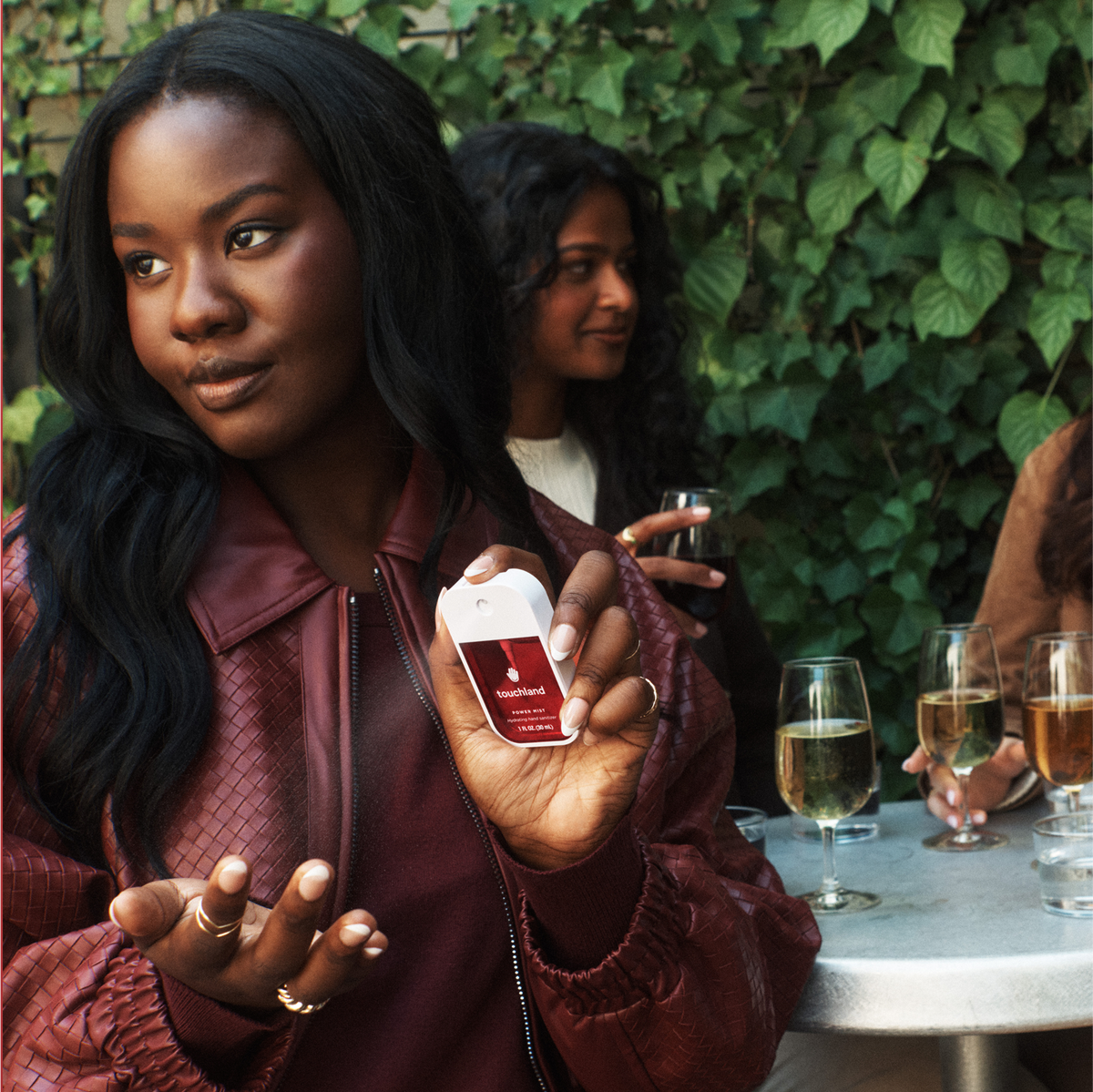 Woman holding a product packaging with a blurred outdoor setting