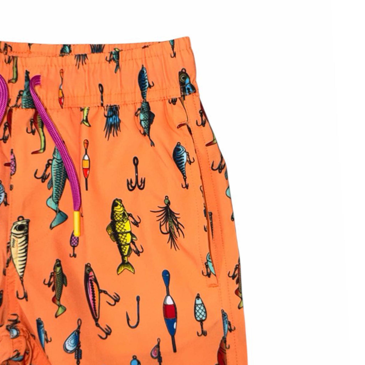 Close-up of orange youth swim shorts with colorful fishing lure print, showing waistband, drawstring, and side pocket.