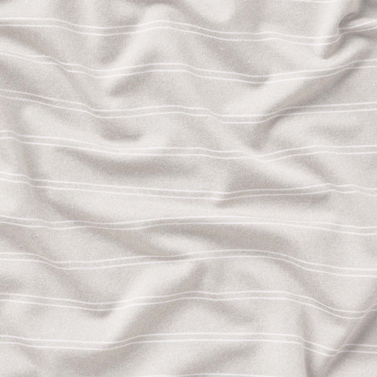 Close-up of white fabric with subtle texture and folds