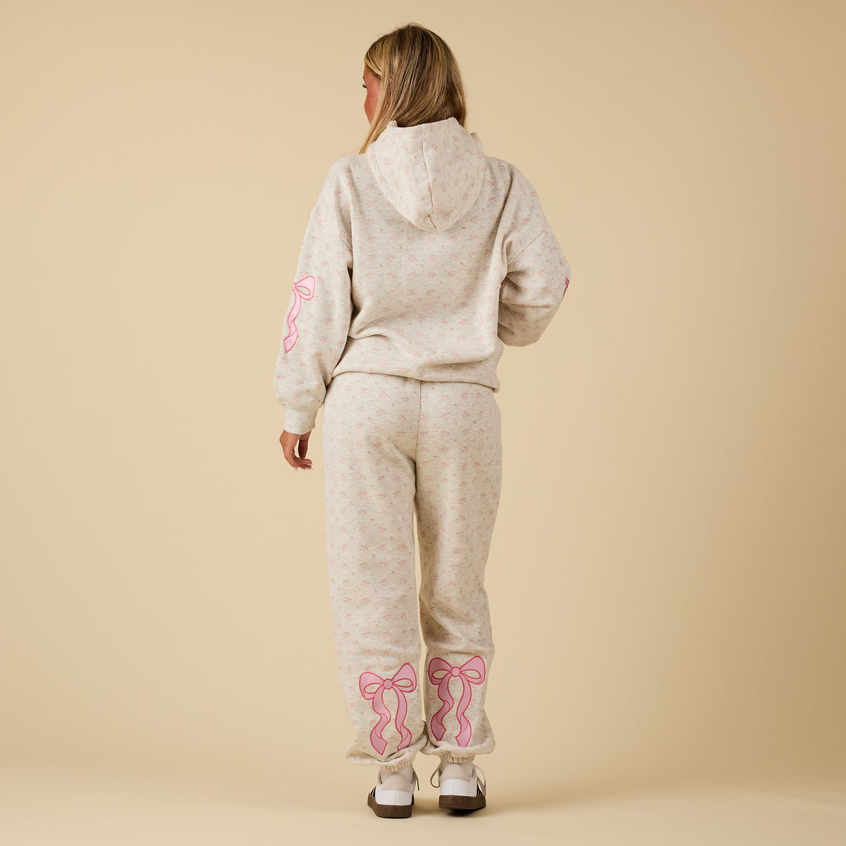 back view of the Full outfit with model wearing Alice Pink Bow Sweatpants and matching hoodie.