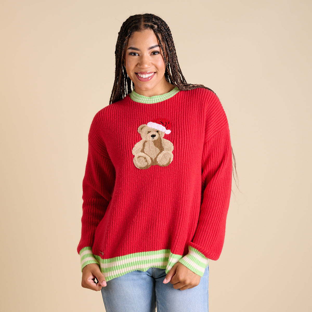Full view of red holiday sweater featuring teddy bear with Santa hat and striped trim.