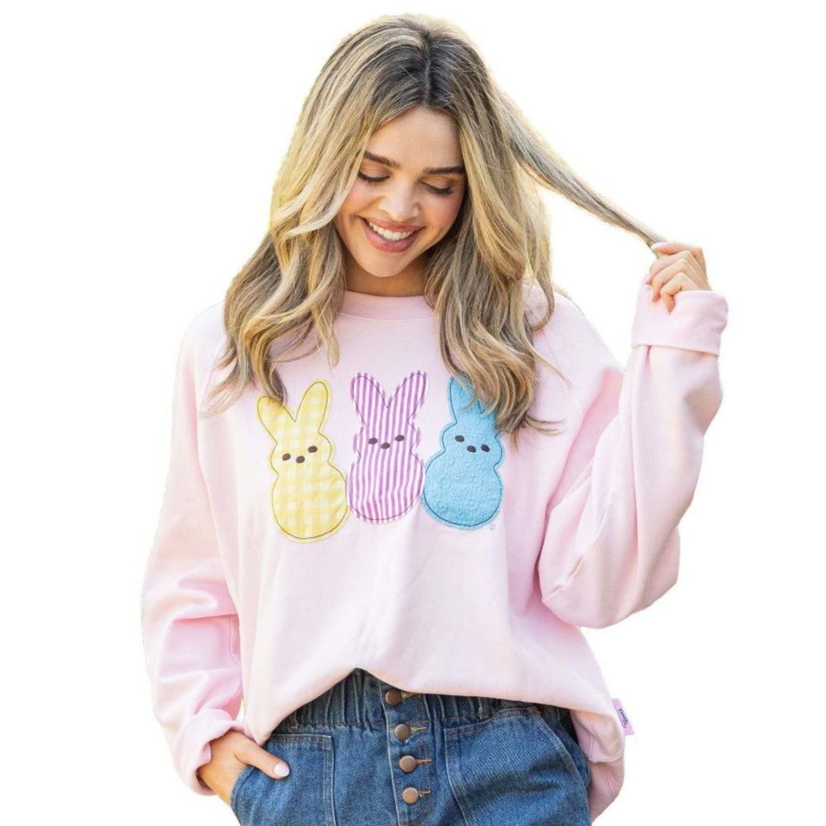 Woman wearing pink Simply Southern crewneck sweatshirt with three pastel Peeps bunny appliqués on front.