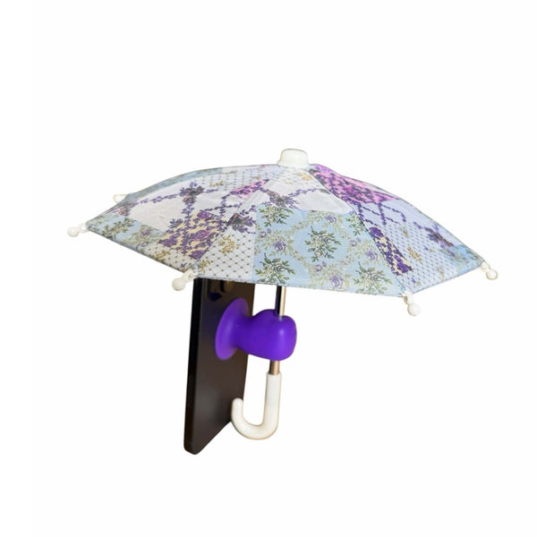 Mini umbrella with a purple and blue floral design attached to a smart phone shown on a white background