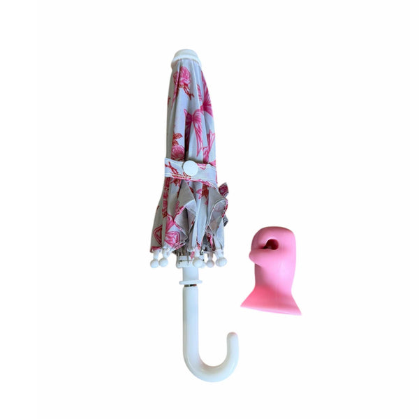 Floral-patterned umbrella with a pink holder on a white background