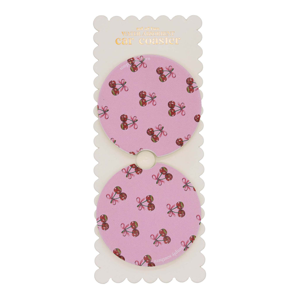 Set of two round car coasters with cut-out notch, displayed on backing card, featuring a pink background with repeating cherry and bow pattern.
