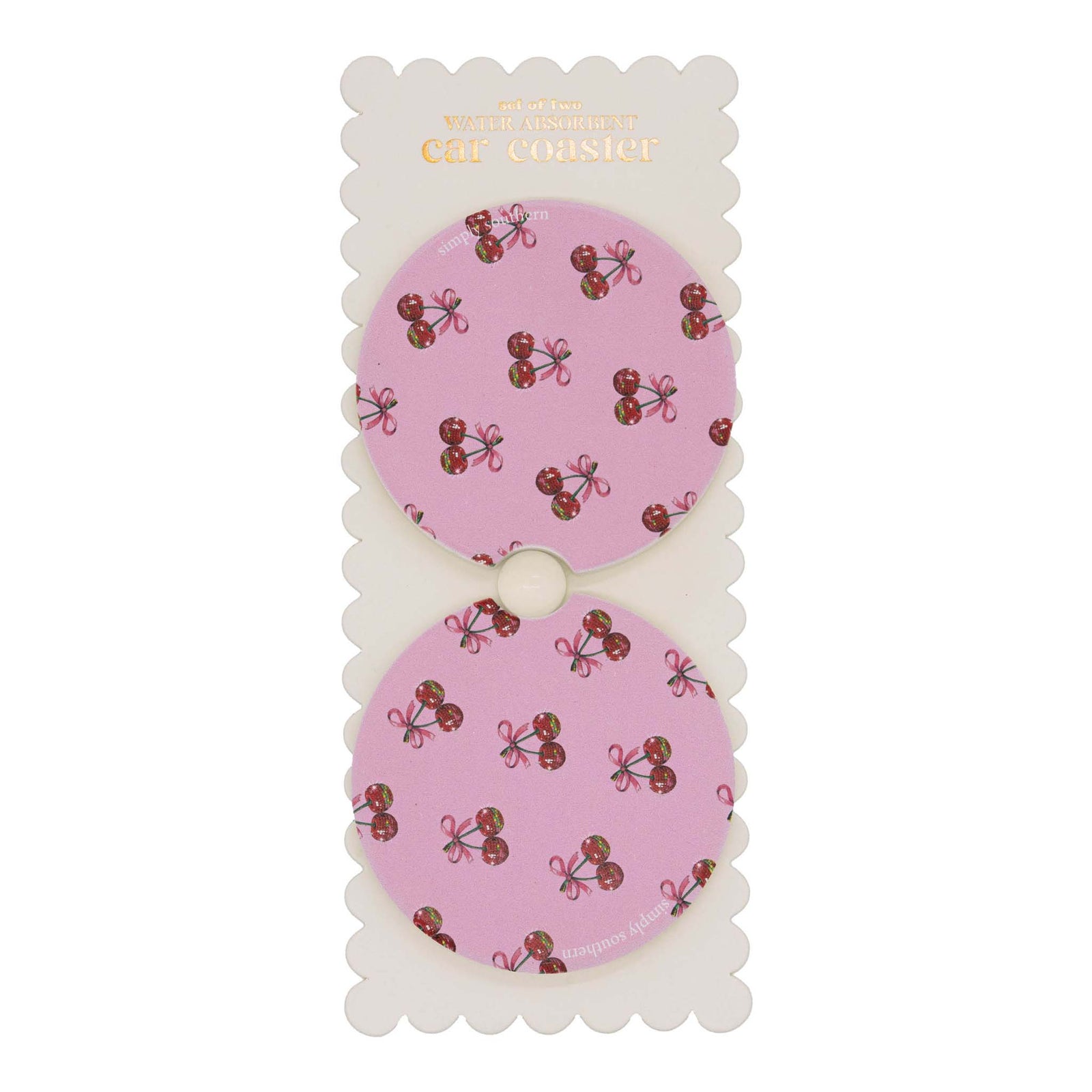 Set of two round car coasters with cut-out notch, displayed on backing card, featuring a pink background with repeating cherry and bow pattern.