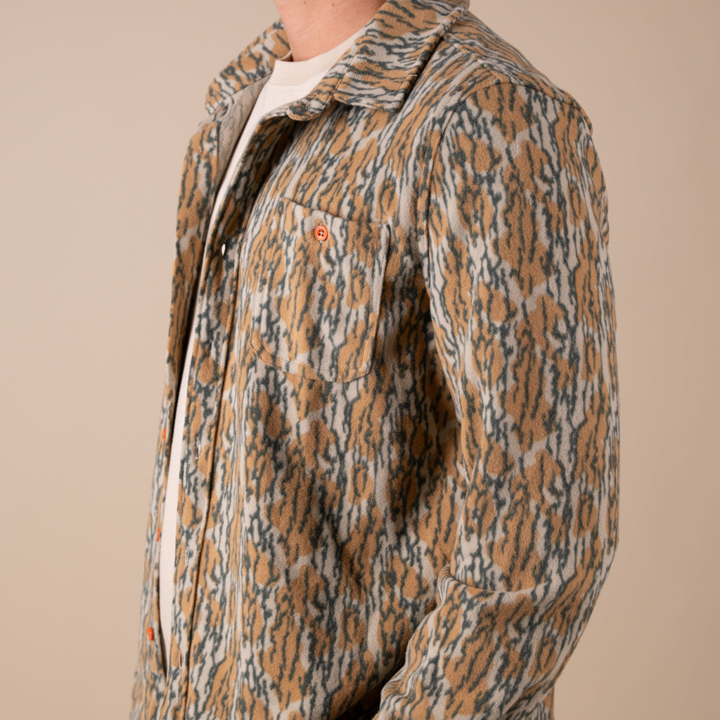 Patterned shacket worn by a person on a beige background