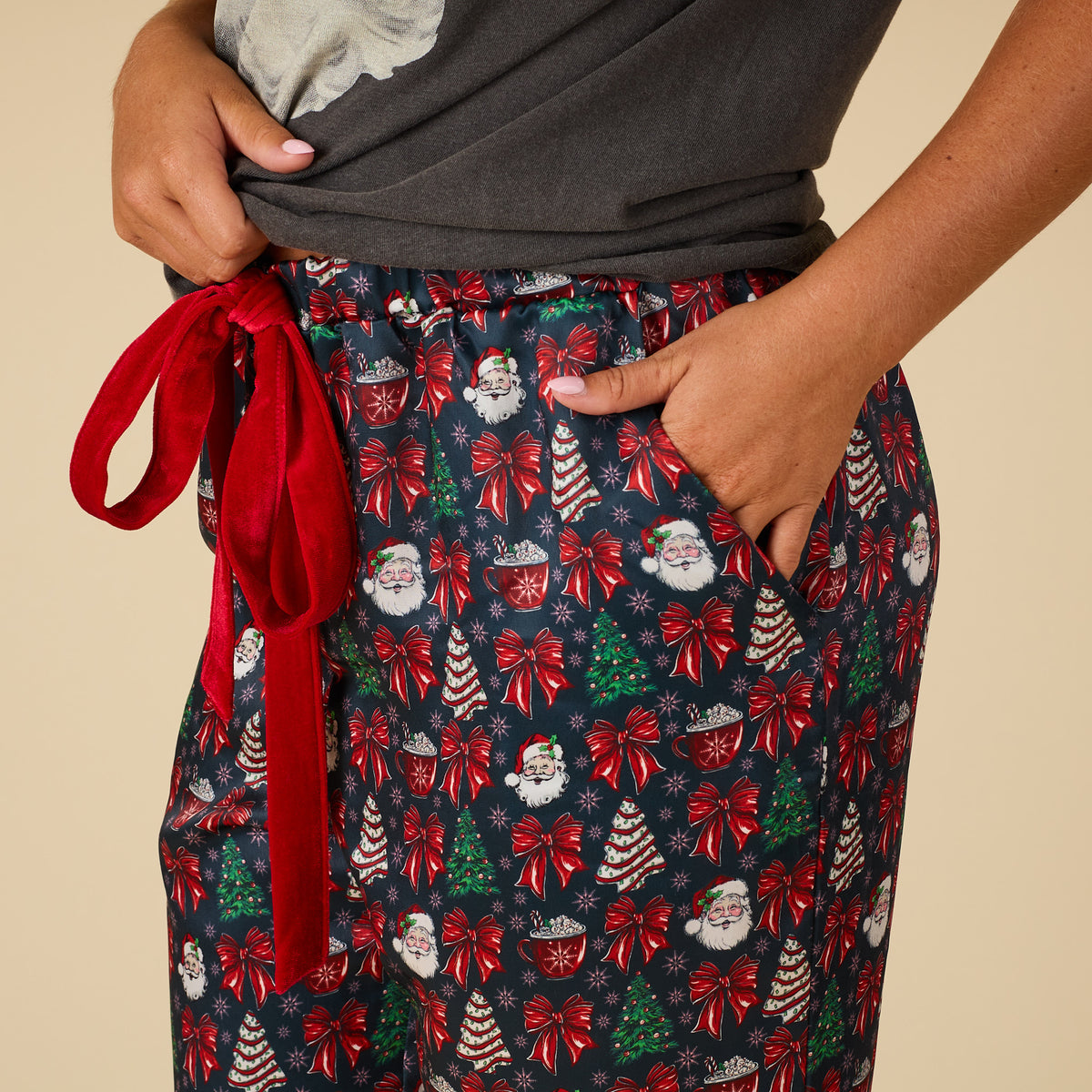 Side view of Women’s Christmas Cake Pajama Pants with red drawstring waistband and allover holiday design.