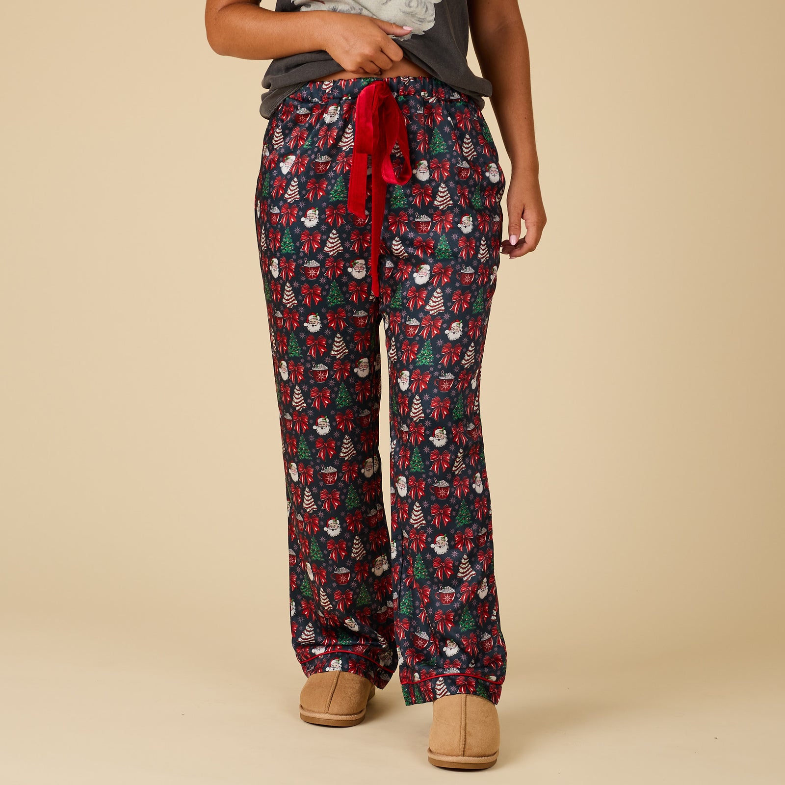 Front view of Women’s Christmas Cake Pajama Pants in navy with holiday print, red drawstring waistband, and side pockets.