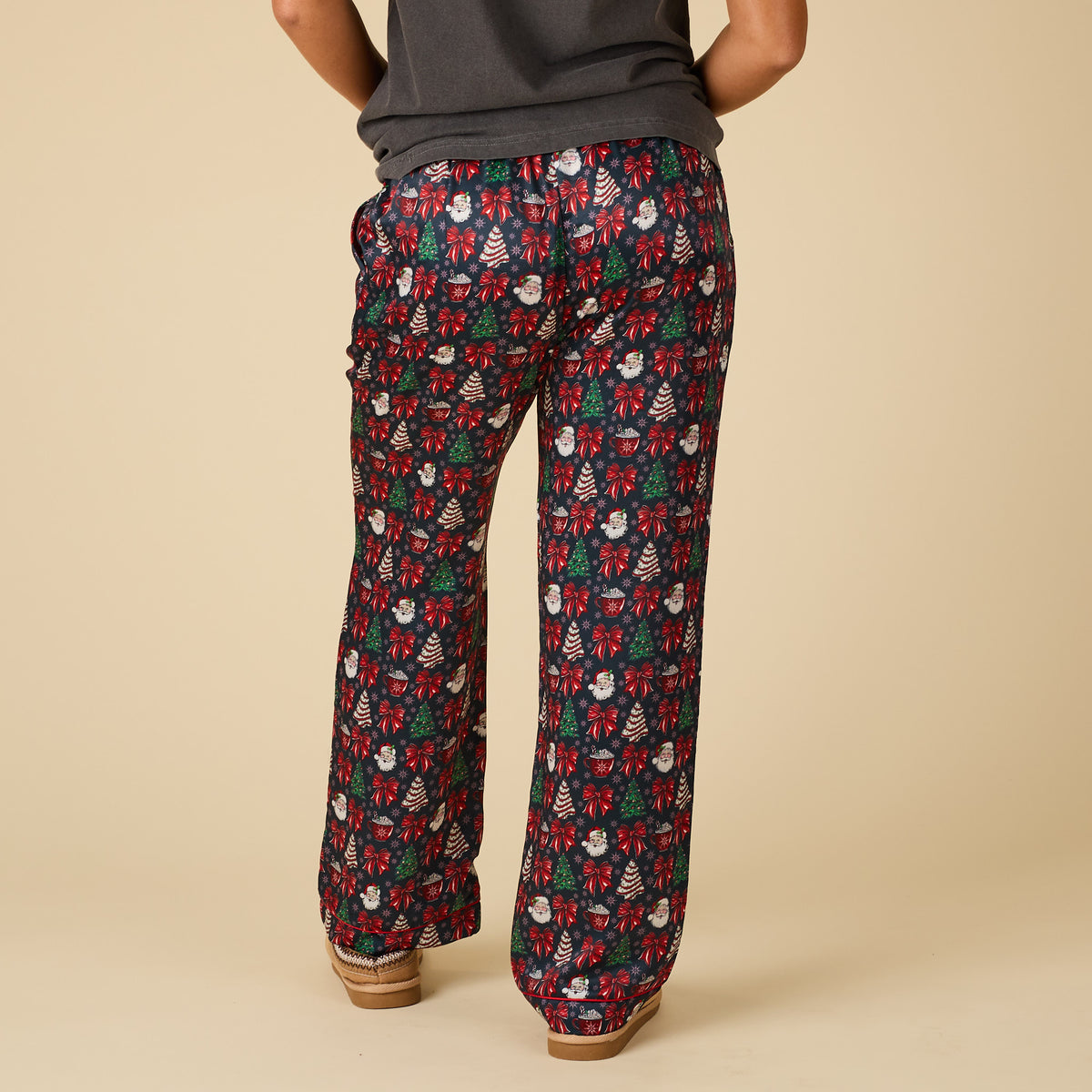 Back view of Women’s Christmas Cake Pajama Pants featuring Santa, bows, and Christmas tree print.