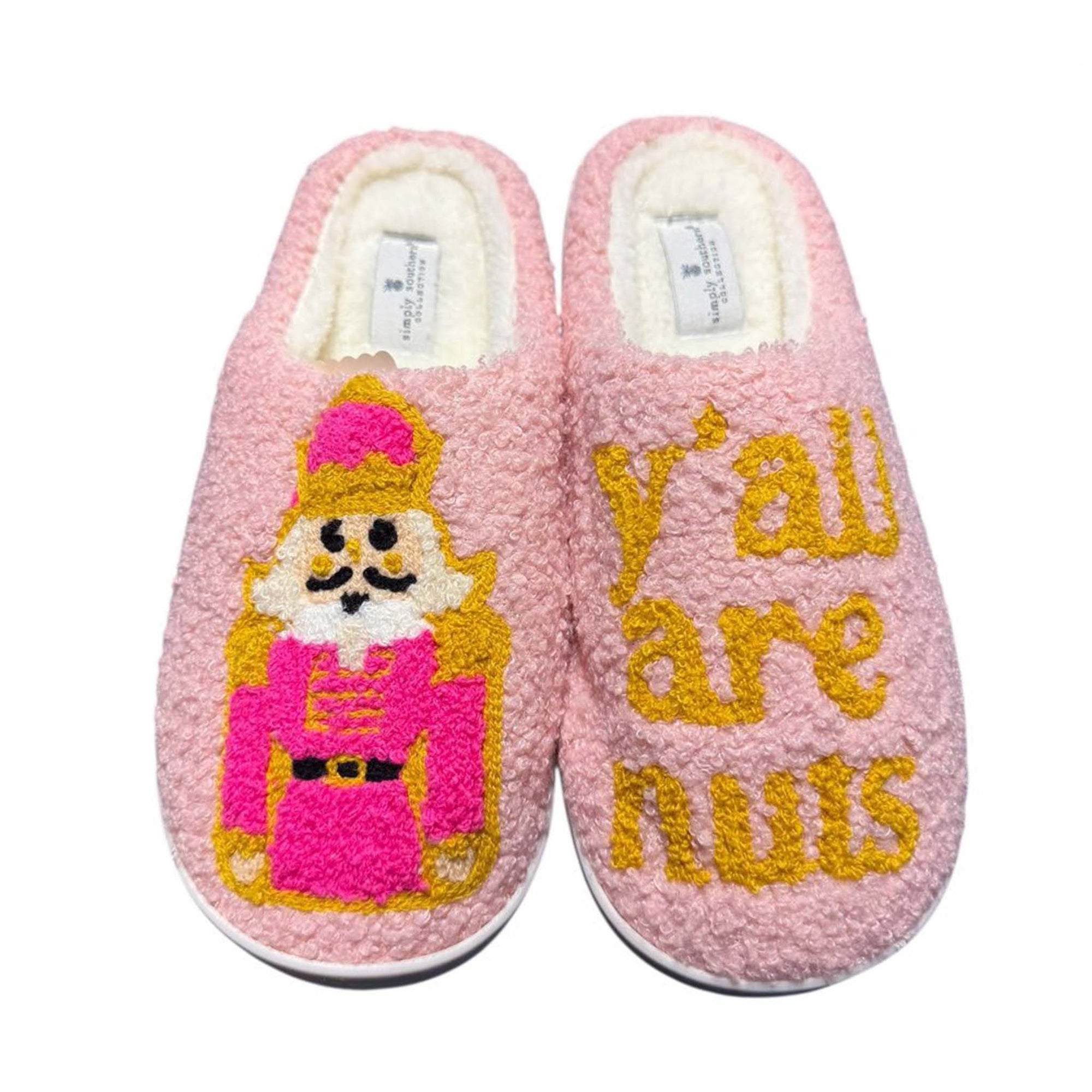 Pink slippers with a Nutcracker design and 'y'all are nuts' text on a white background