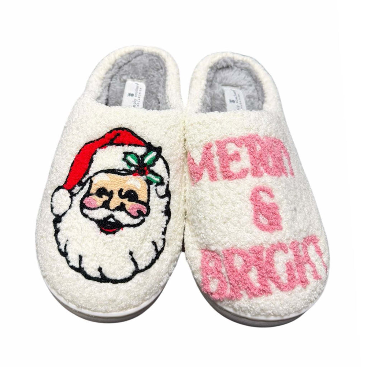 Pair of slippers with Santa Claus face and 'Merry & Bright' text on a white background