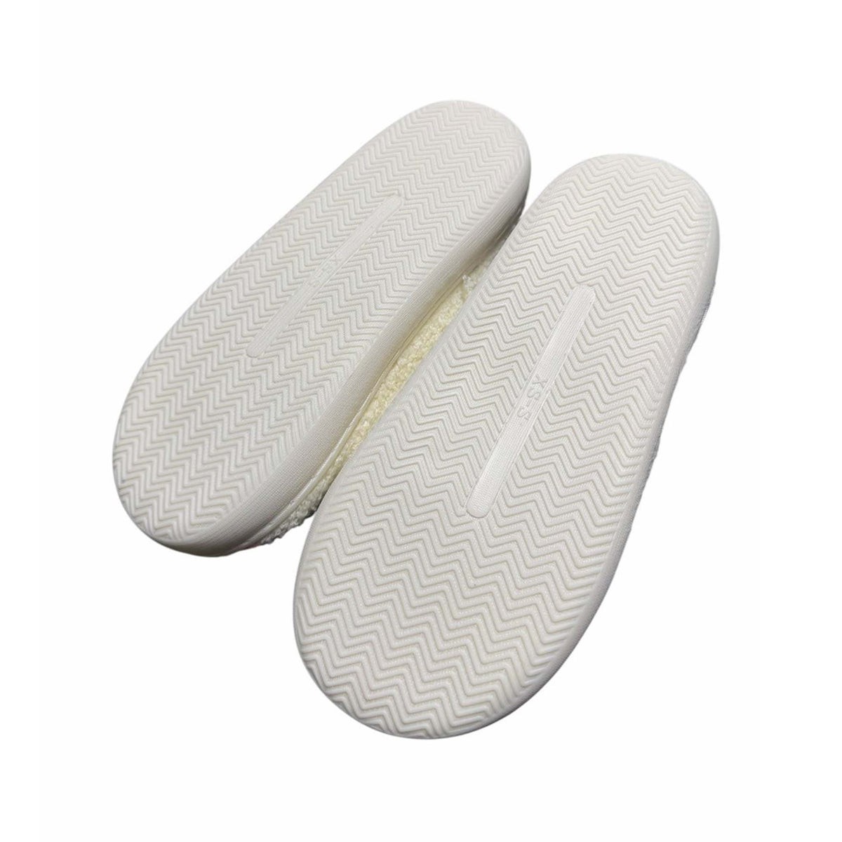 White shoe bottom soles with a zigzag pattern on a white background
