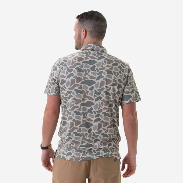 Man wearing Burlebo's Classic Deer Camo Performance Polo on a white background