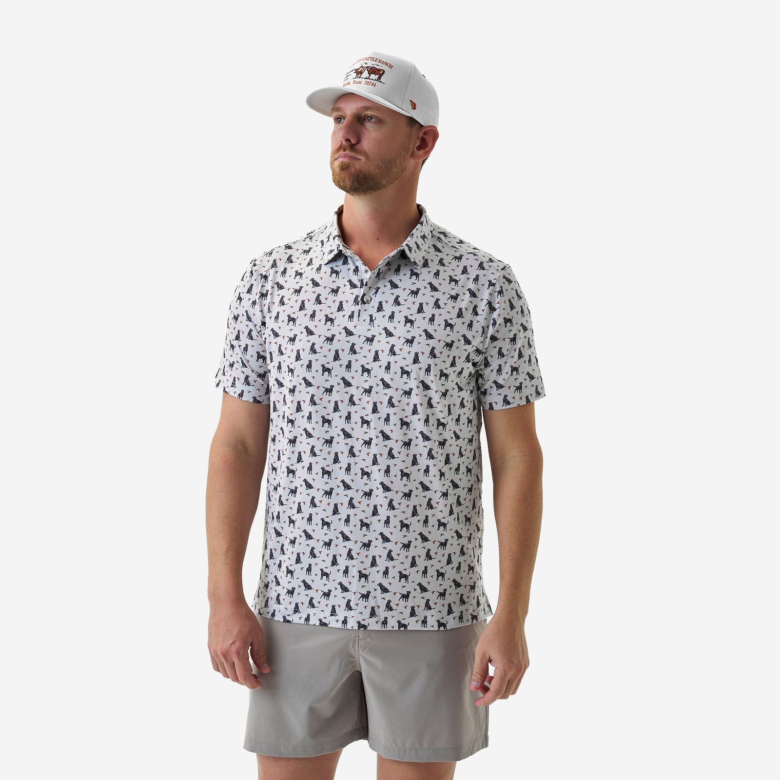 Man wearing a patterned shirt and cap on a white background