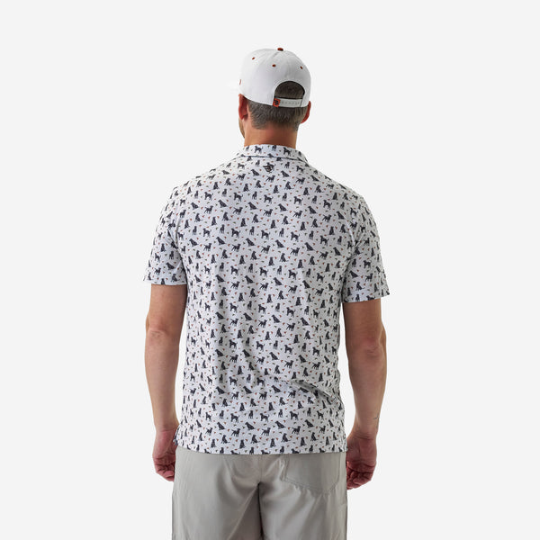 Man wearing a patterned shirt and cap on a white background