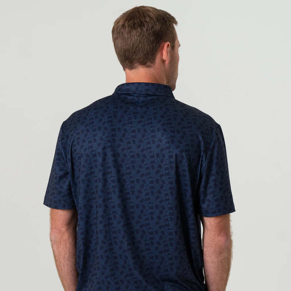 Burlebo Stars and Stripes Short Sleeve Performance Polo, sizes S-XXL, Back view of a man wearing the Burlebo Stars and Stripes Performance Polo in navy with an all-over navy-on-navy small American Flag design.