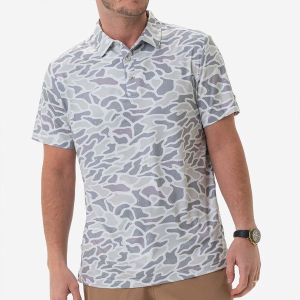 Man wearing Burlebo's White Camo Performance Polo in front of a white backdrop