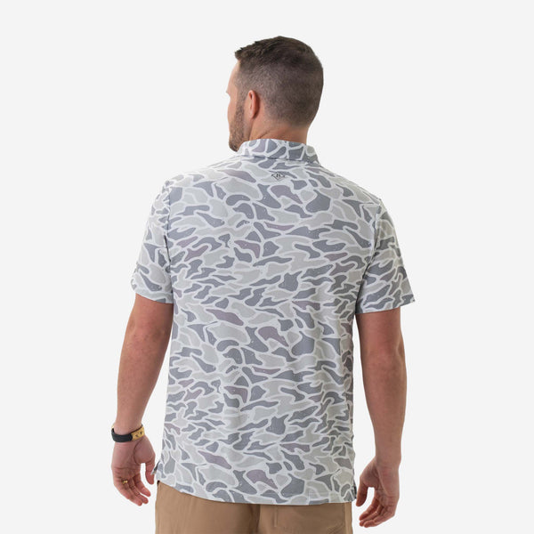 Man wearing Burlebo's White Camo Performance Polo in front of a white backdrop