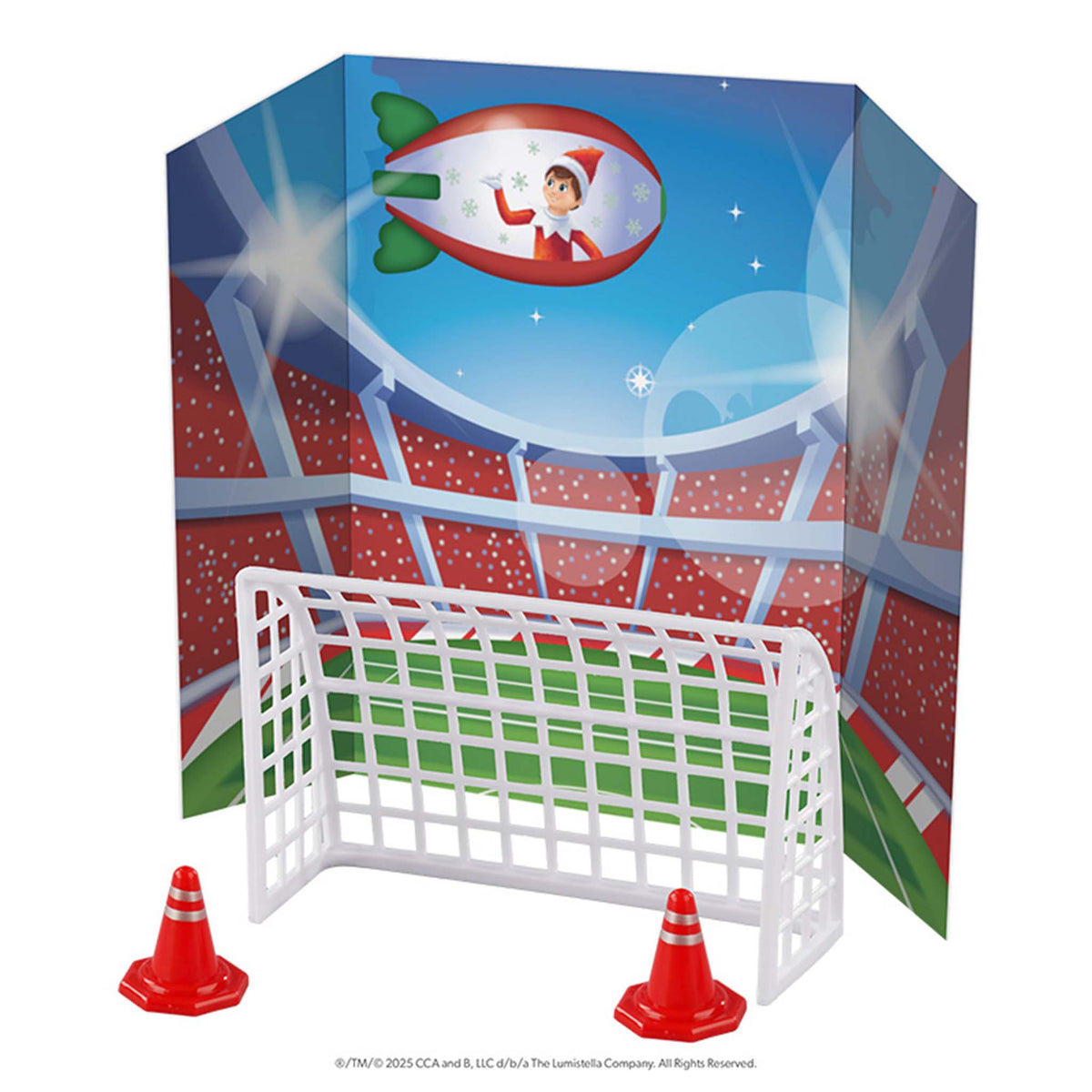 Children's sports play set with goal, cones, and Elf on the Shelf character in the background