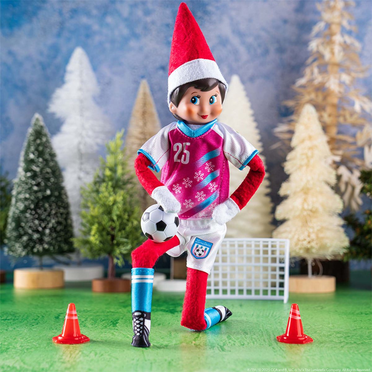 Elf on the Shelf in sports gear with a soccer ball and cones on a Christmas-themed background