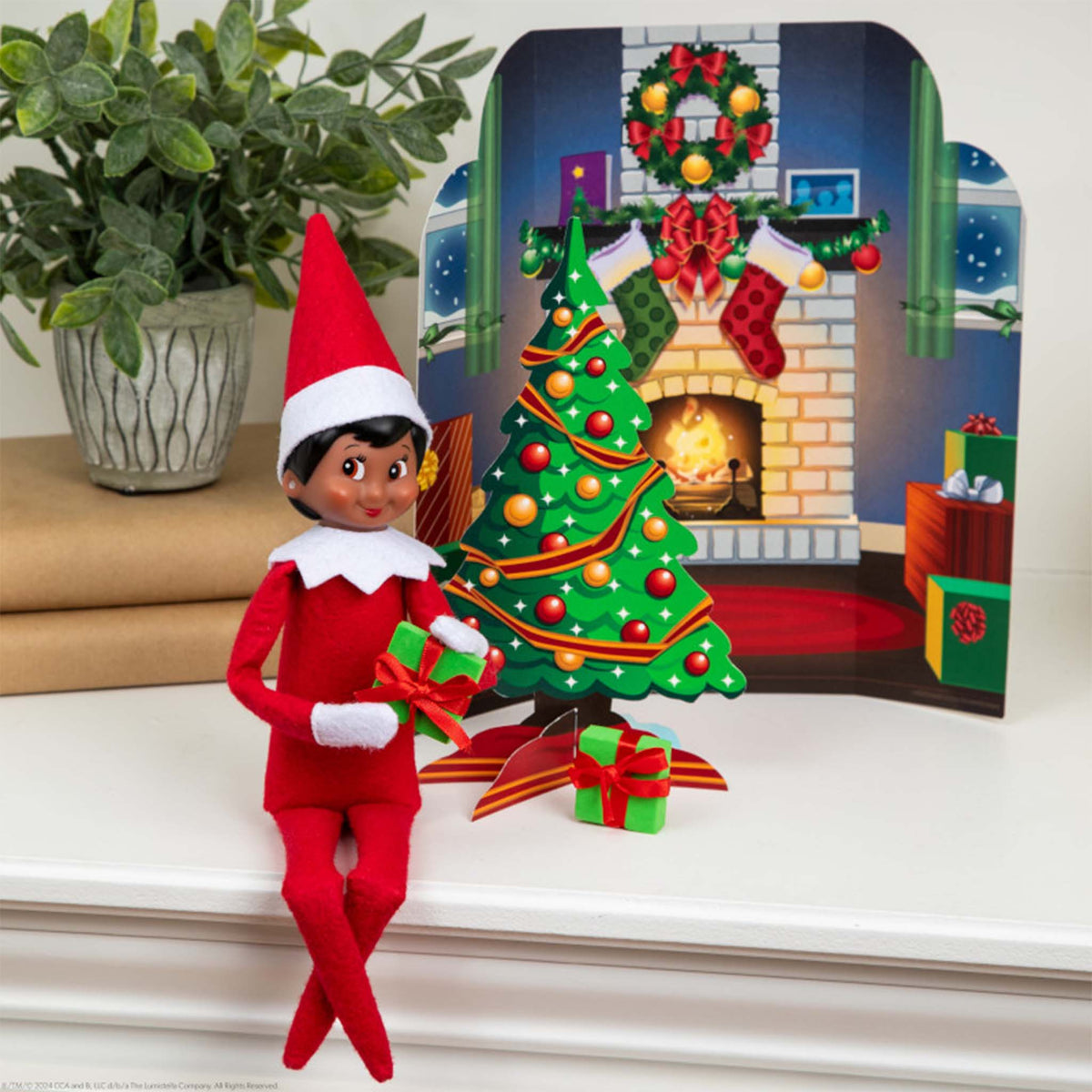 Elf on the Shelf with a decorated Christmas tree and fireplace backdrop