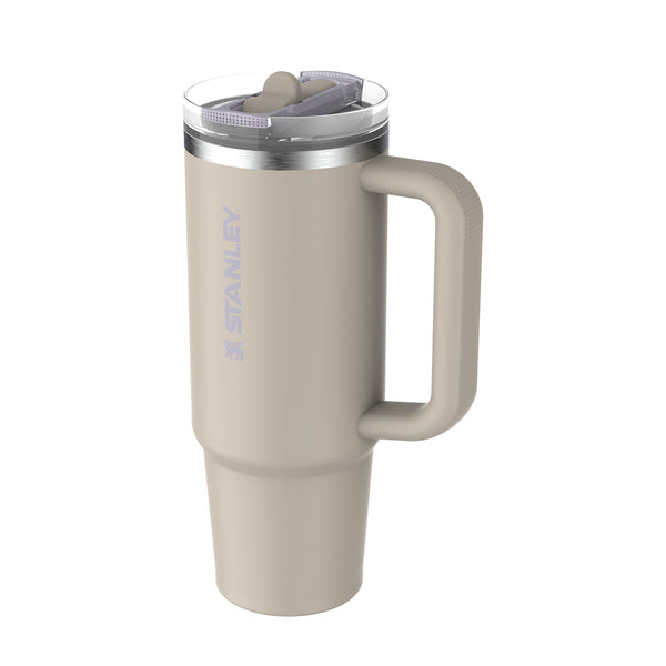 Beige Stanley travel mug with handle on a white background