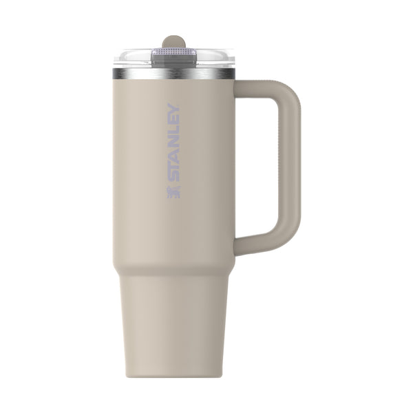 Beige Stanley mug with handle on a white background