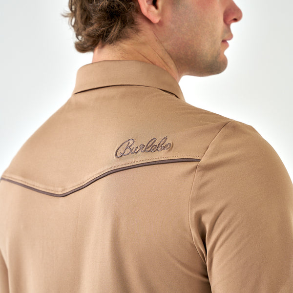 Man wearing a tan shirt with a brand logo on the shoulder against a white background