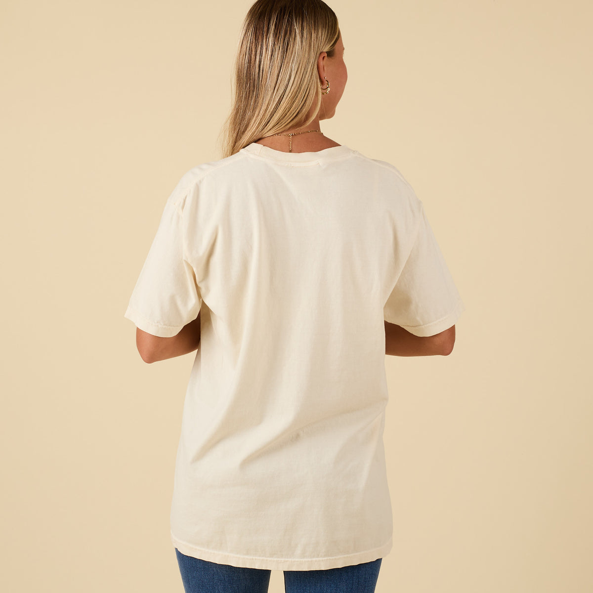 Back view of ivory short sleeve t-shirt with plain design.