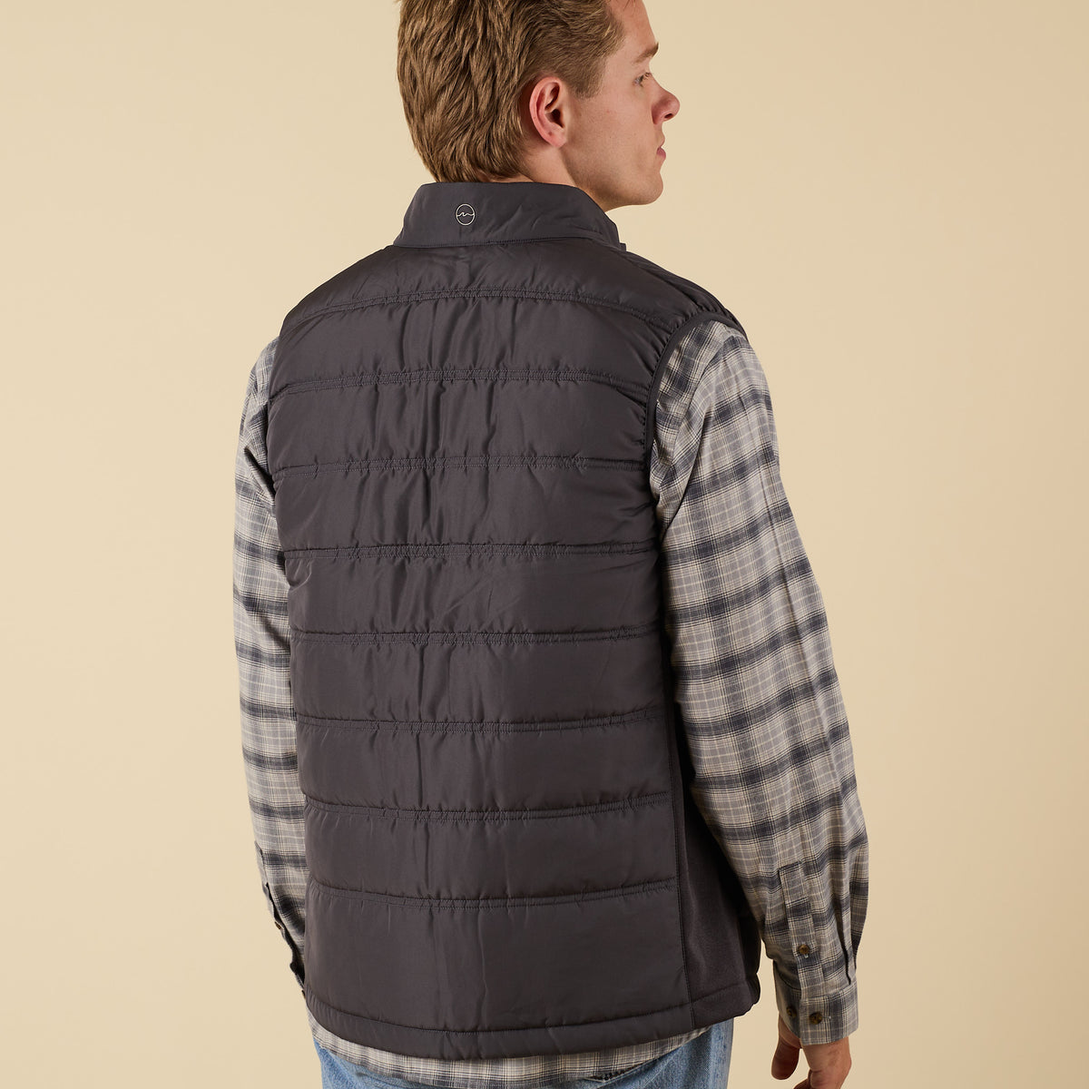 7. Back view of Coast Apparel Foredeck Vest in Washed Black on model
