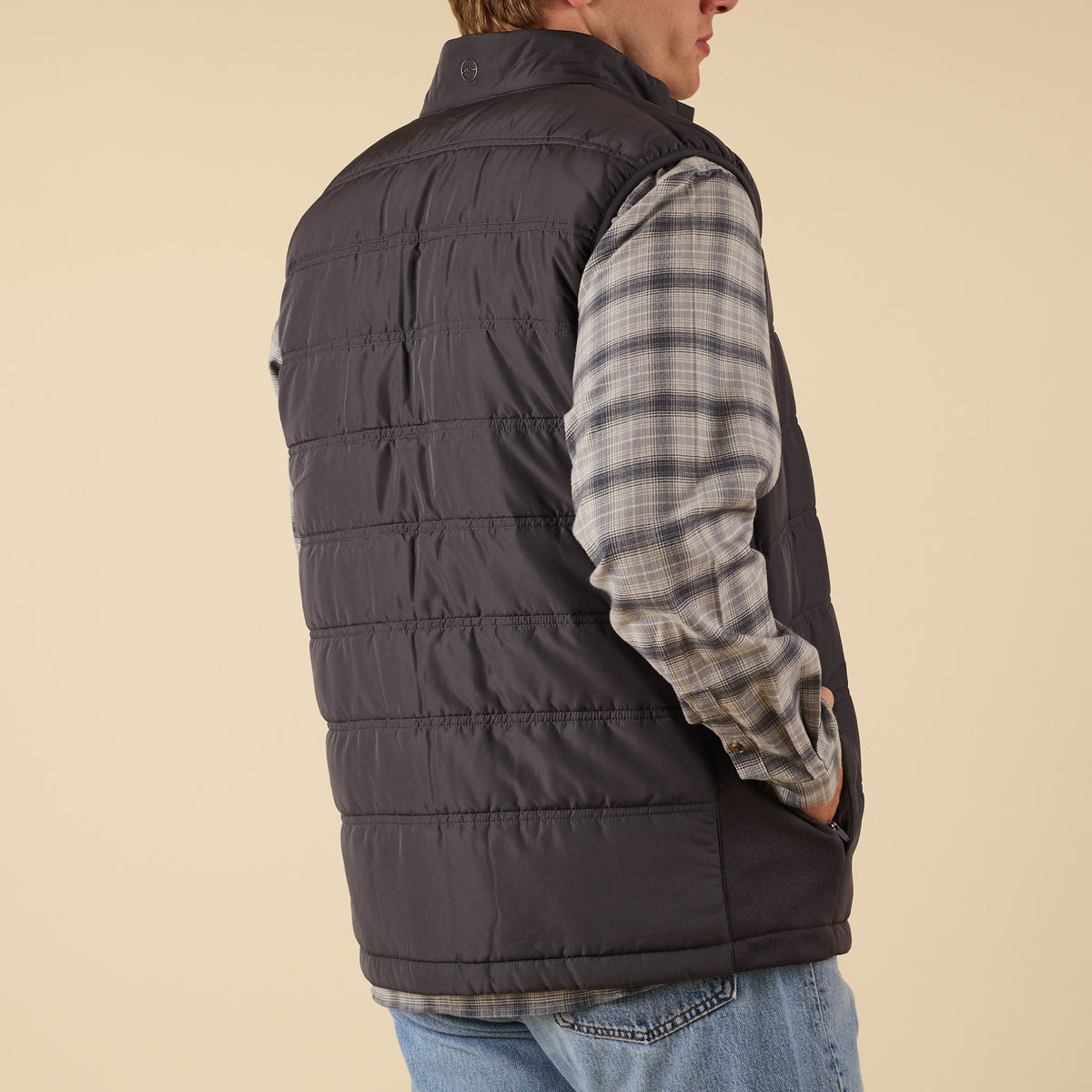 Side back view of Coast Apparel Foredeck Vest in Washed Black styled casually