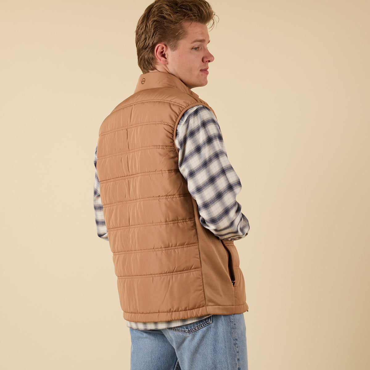 Back view of Coast Apparel Foredeck Vest in Chestnut on model wearing plaid shirt