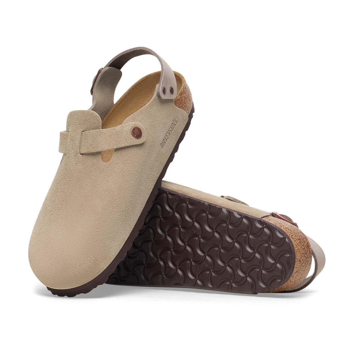 Pair of beige sandals with brown soles on a white background