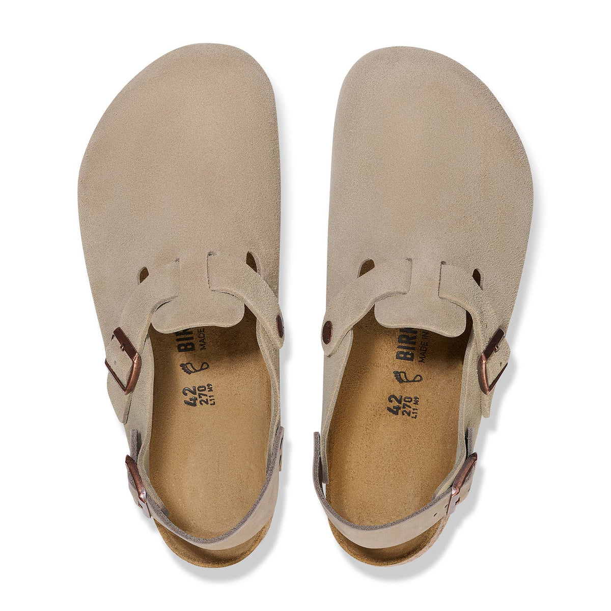 Pair of beige shoes with brown buckles on a white background