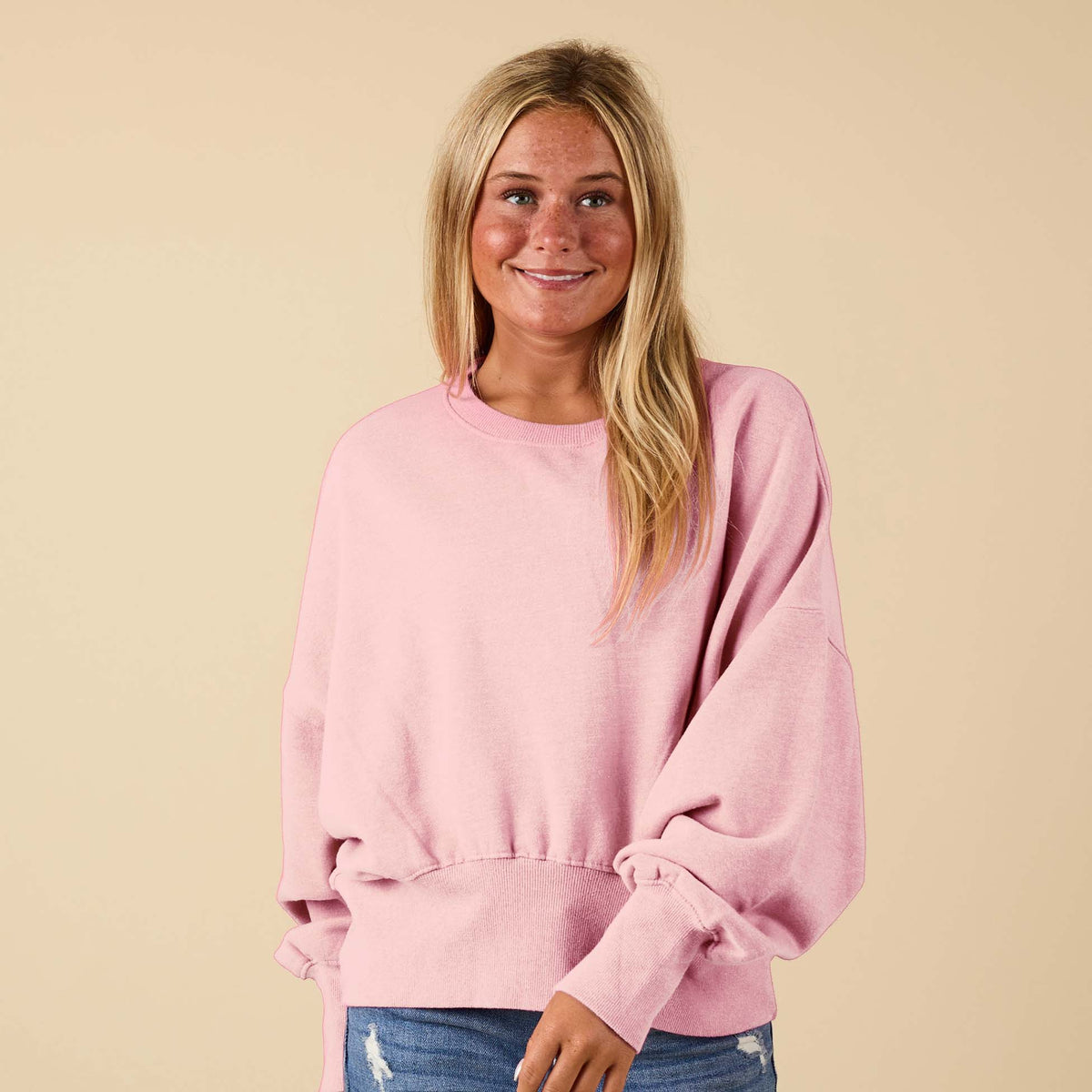 Beach Pink crewneck sweatshirt with oversized sleeves, modeled from the front
