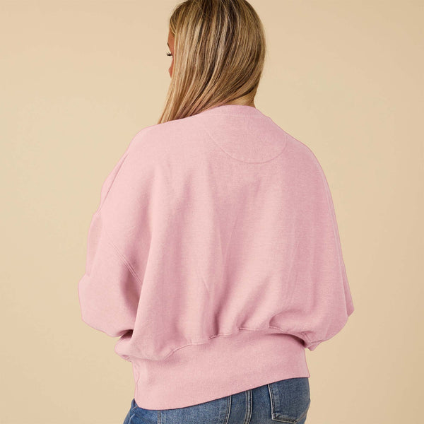 Beach Pink crewneck sweatshirt with oversized sleeves, modeled from the back.