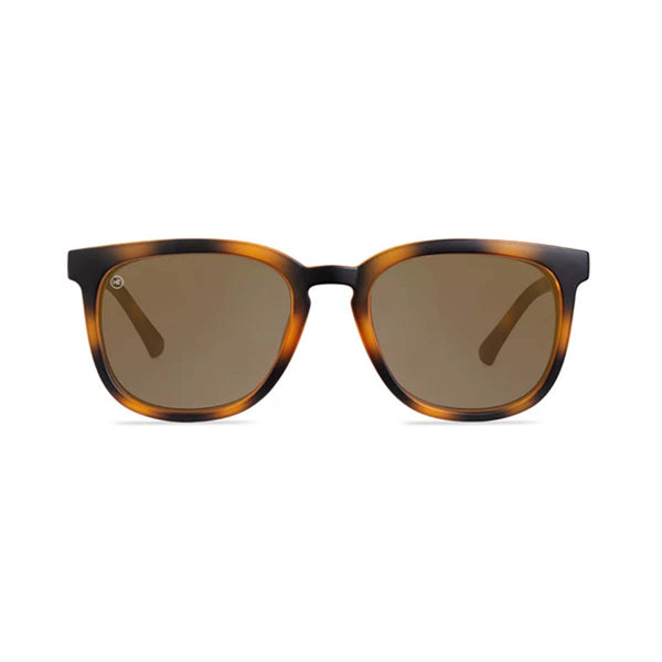 Sunglasses with tortoiseshell frame and brown lenses on a white background