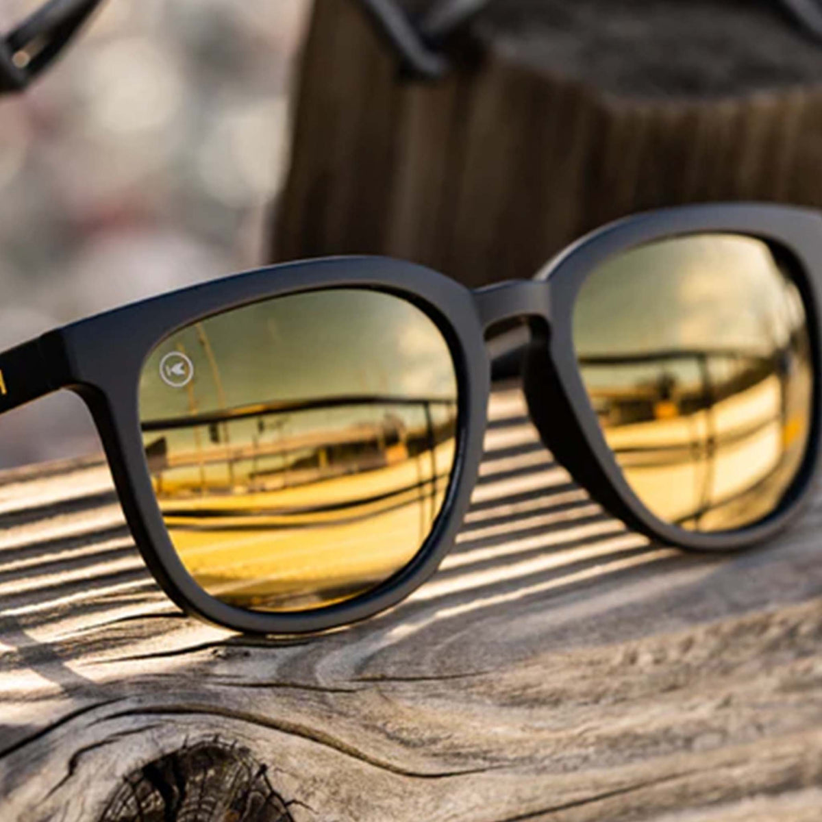 Sunglasses with reflective lenses on a wooden surface