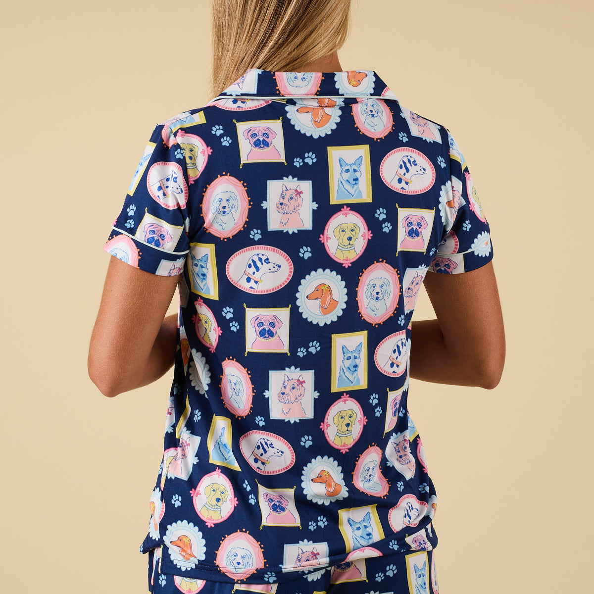 Full back view of blue pajama top with playful dog portrait design and matching shorts.