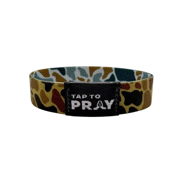 Wristband with camouflage pattern and 'Tap to Pray' text on a white background