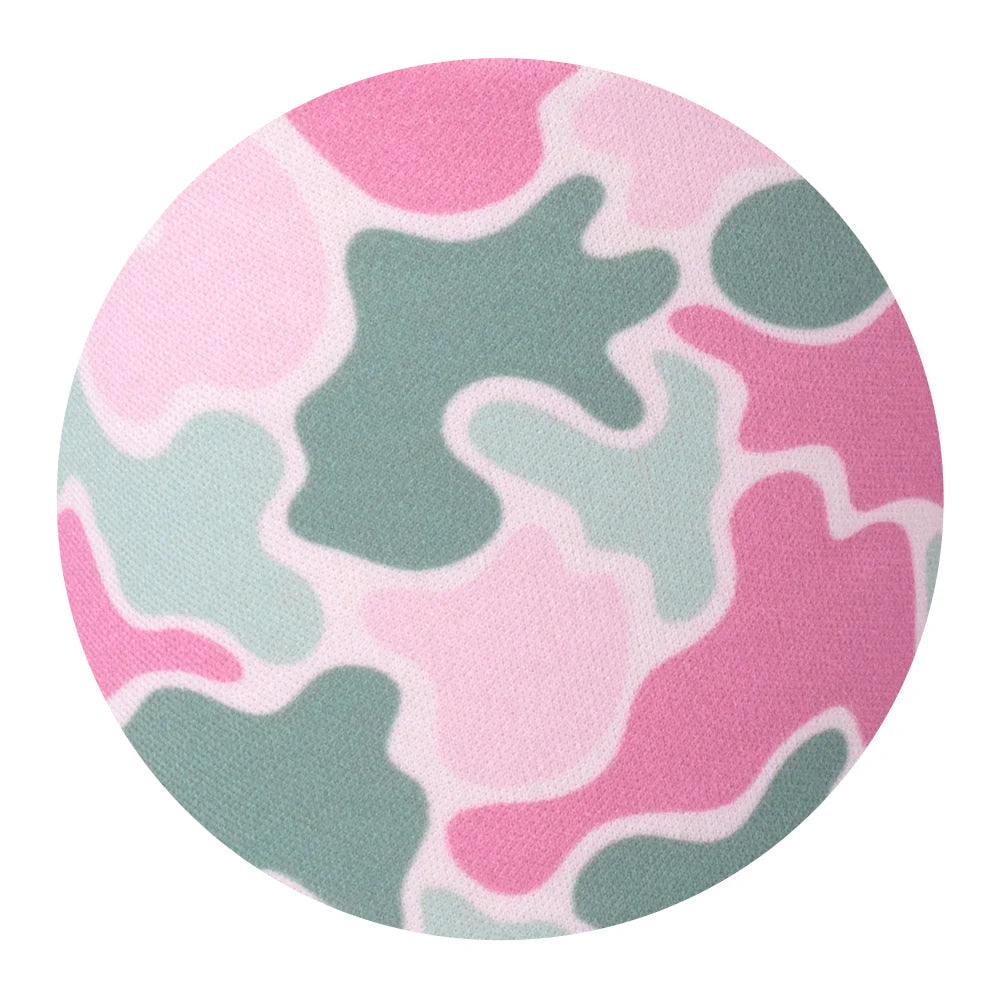 Close-up of Blushing Camo print featuring abstract camouflage shapes in pink, light green, and white.