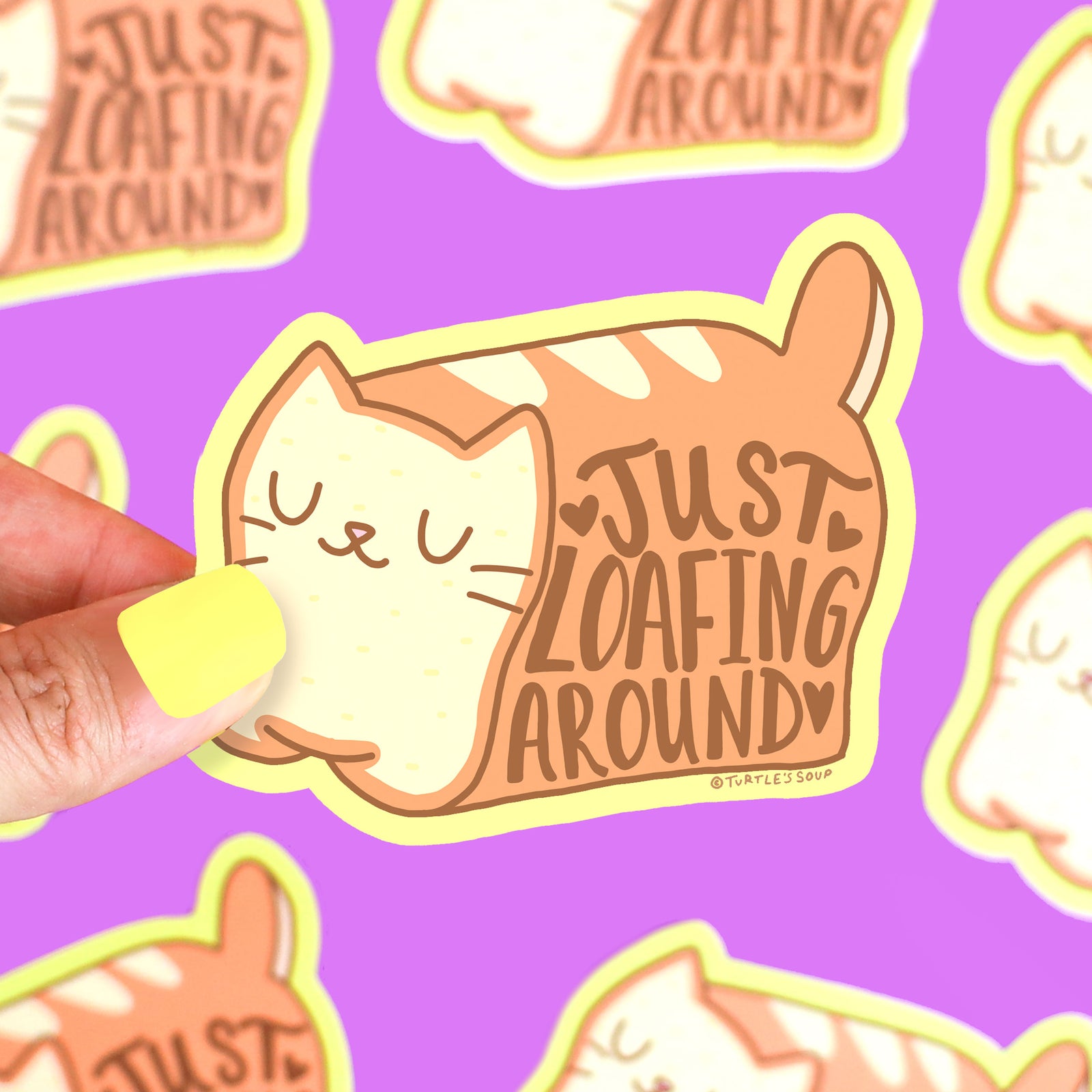 Sticker of a cat with 'Just Loafing Around' text held by a hand on a purple background with similar stickers.