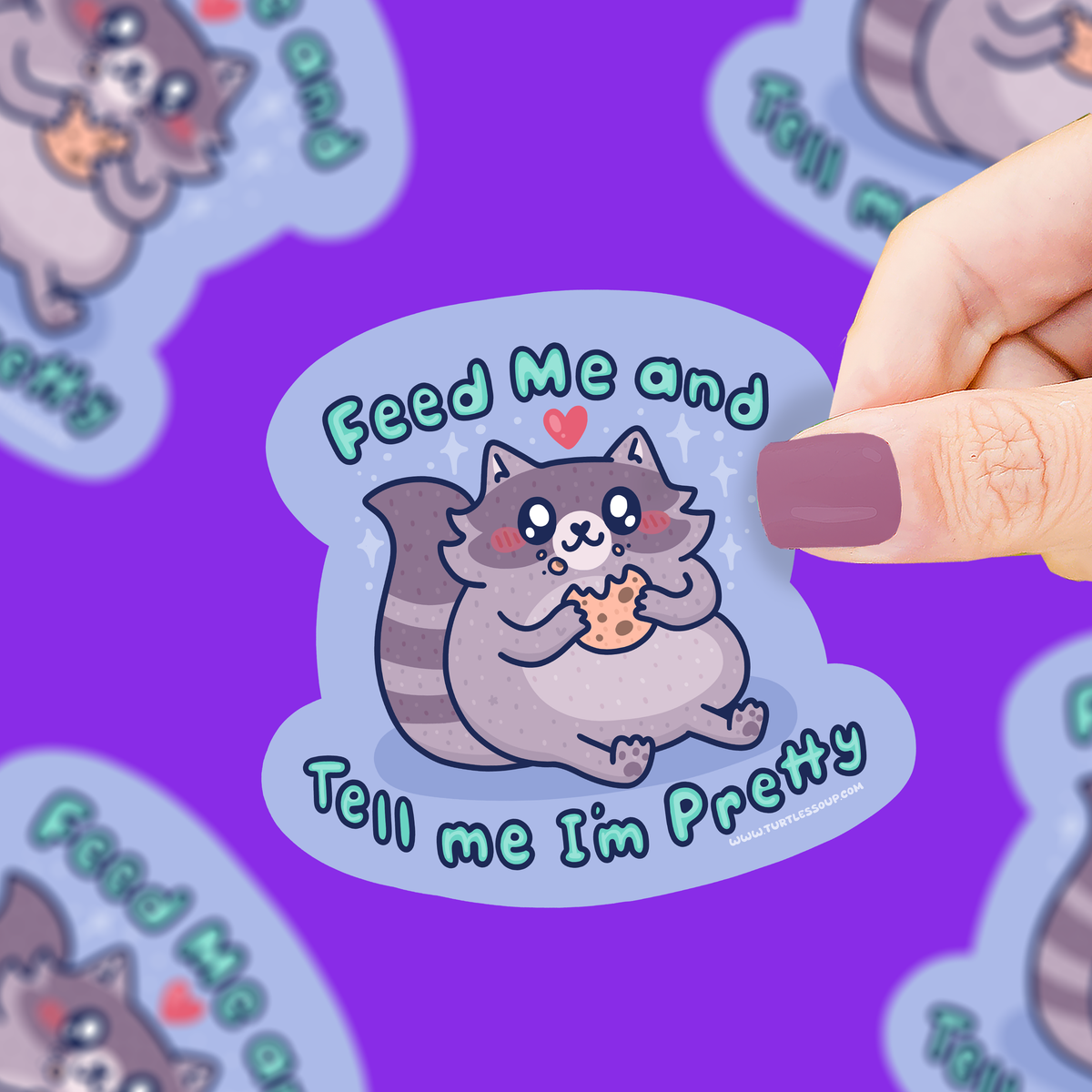 Sticker with a raccoon illustration and text held by a hand on a purple background with more stickers.