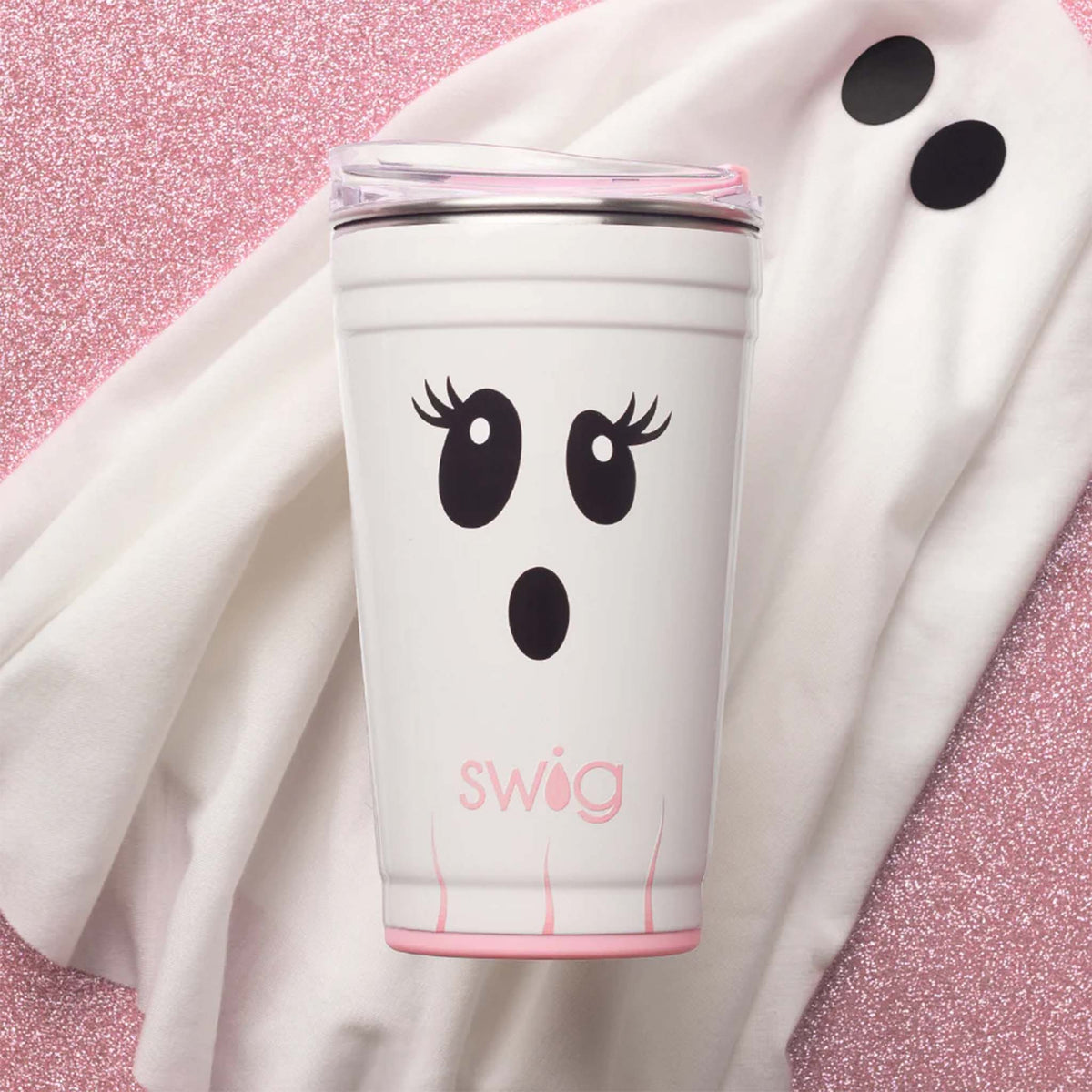 Swig 24oz Party Cup in Boo Crew Ghost displayed on white fabric and pink glitter background with ghost face design.