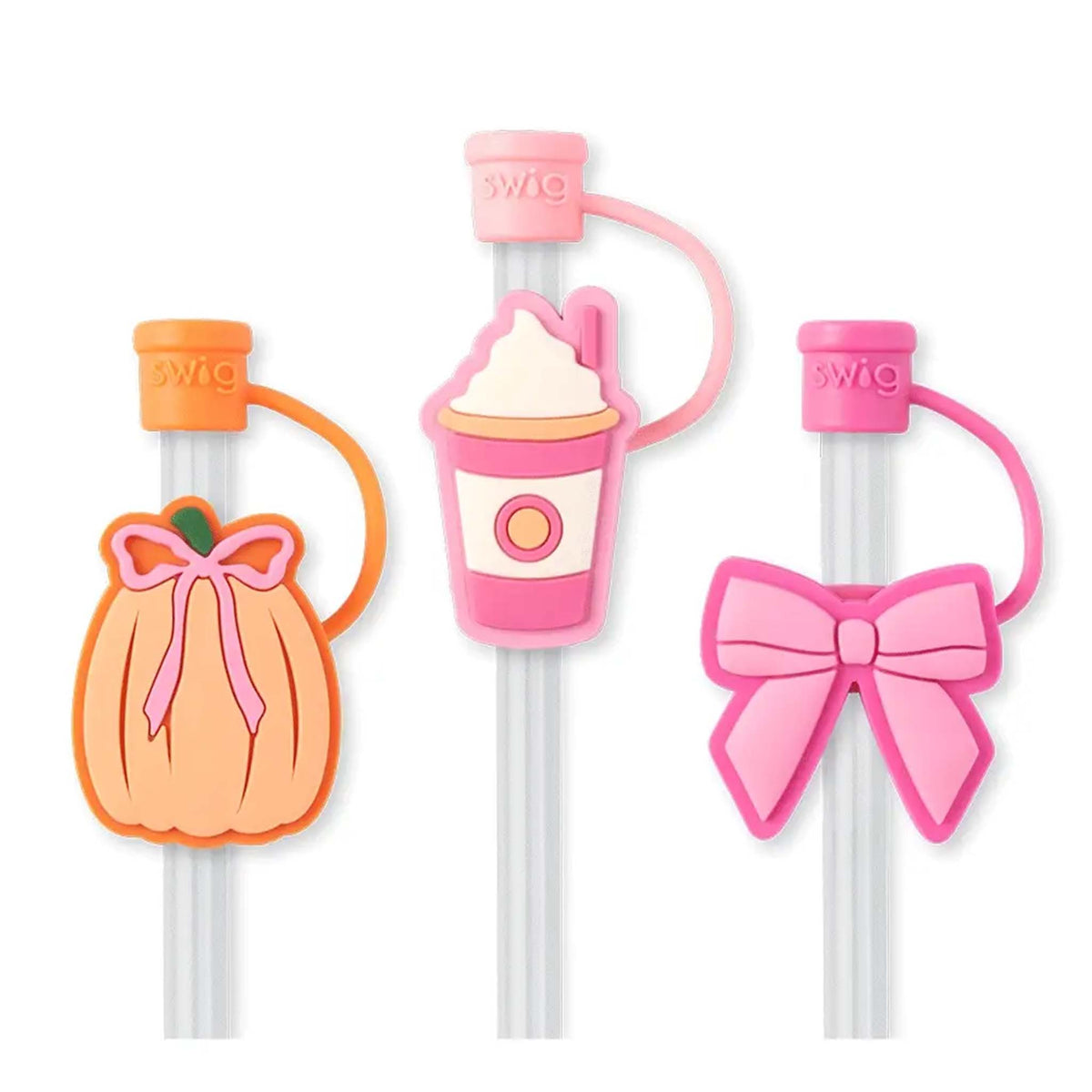 Set of three Swig Life straw toppers shaped like a pumpkin, a pink drink cup, and a pink bow.